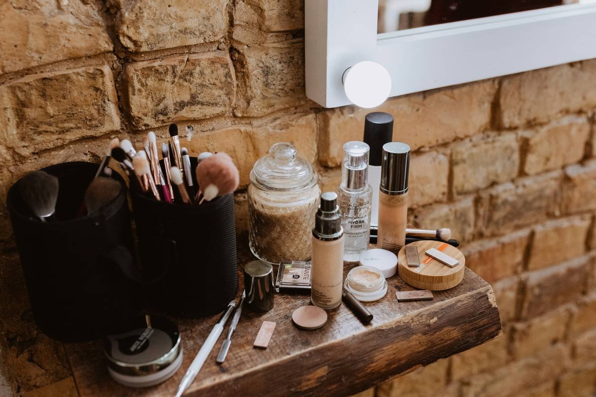 Side-by-side image: cluttered makeup drawer vs. neatly organized acrylic vanity organizer with labeled compartments